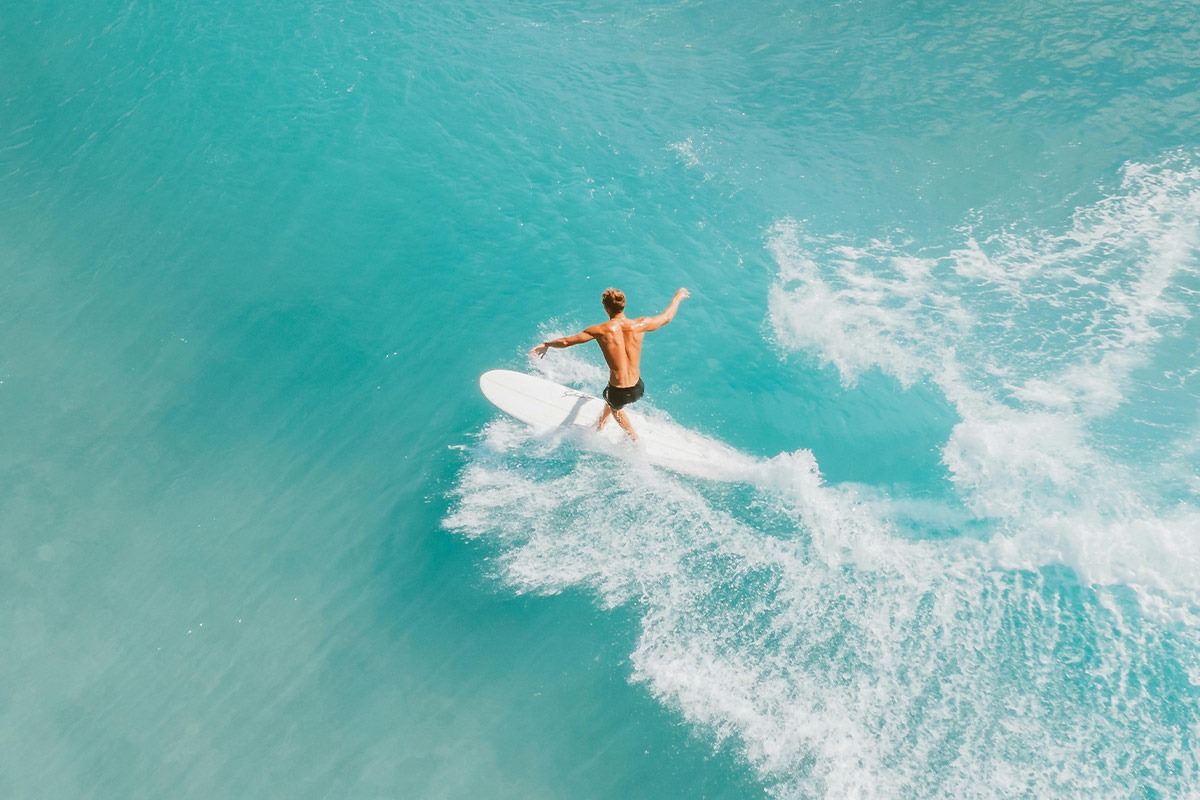 A person surfing on the turquoise waters of Surfers Paradise 